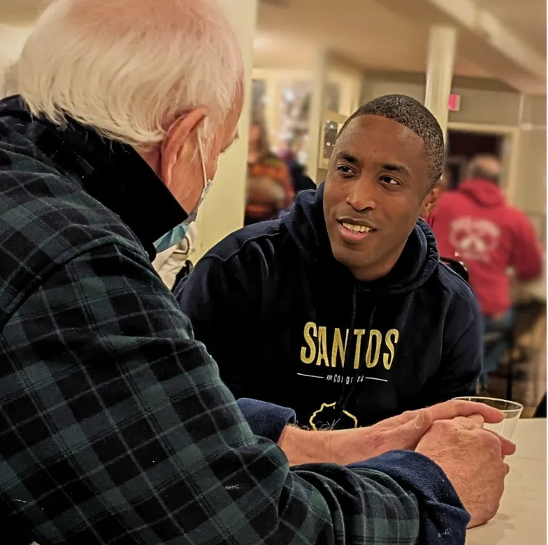 Lorenzo Santos with an elder