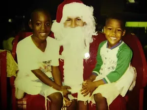 Young Lorenzo Santos and his brother with Santa